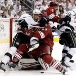 Los Angeles Kings' Jordan Nolan (71) pulls Phoenix Coyotes' Derek Morris (53) down as Keith Yandle (3) and Kings' Brad Richardson (15) tangle in the second period during Game 2 of the NHL hockey Stanley Cup Western Conference finals, Tuesday, May 15, 2012, in Glendale, Ariz. (AP Photo/Ross D. Franklin)