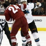 San Jose Sharks center Andrew Desjardins (10) and Phoenix Coyotes center Kyle Chipchura (24) battle in the first period during an NHL hockey game on Friday, Dec. 27, 2013, in Glendale, Ariz. (AP Photo/Rick Scuteri)