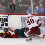 Phoenix Coyotes center Antoine Vermette (50) is called for tripping as Minnesota Wild defenseman Jared Spurgeon (46) falls to the ice during overtime in an NHL hockey game Wednesday, March 27, 2013, in St. Paul, Minn. The Wild won 4-3. (AP Photo/Genevieve Ross)