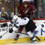 Phoenix Coyotes defenseman Connor Murphy (5) and San Jose Sharks defenseman Dan Boyle (22) battle for the puck in the second period during an NHL hockey game on Friday, Dec. 27, 2013, in Glendale, Ariz. (AP Photo/Rick Scuteri)