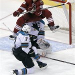 Phoenix Coyotes' Antoine Vermette (50) leaps out of the way of a shot on goal as San Jose Sharks' Brad Stuart (7) and goalie Thomas Greiss defend during the third period of an NHL hockey game, Wednesday, April 24, 2013, in Glendale, Ariz. The Coyotes won 2-1. (AP Photo/Matt York)