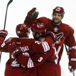 Phoenix Coyotes center Boyd Gordon (15) and Keith Yandle (3) celebrate with Lauri Korpikoski (28) of Finland, after Korpikkoski scored a second-period goal against the Anaheim Ducks during an NHL hockey game Saturday, March 2, 2013, in Glendale, Ariz. (AP Photo/Rick Scuteri)