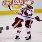 Phoenix Coyotes' Oliver Ekman-Larsson (23) celebrates with Keith Yandle (3) after Ekman-Larsson opened the scoring against the Winnipeg Jets' during first period NHL hockey action in Winnipeg, Monday, Jan. 13, 2014. (AP Photo/The Canadian Press, Trevor Hagan)