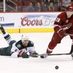 Phoenix Coyotes' Lauri Korpikoski (28), of Finland, goes after the puck as Minnesota Wild's Clayton Stoner (4) falls down during the third period in an NHL hockey game Thursday, Jan. 9, 2014, in Glendale, Ariz. The Wild defeated the Coyotes 4-1. (AP Photo/Ross D. Franklin)