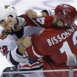 Phoenix Coyotes' Paul Bissonnette (12) and Chicago Blackhawks' Brandon Bollig (52) fight during the second period of an NHL hockey game, Sunday, Jan. 20, 2013, in Glendale, Ariz. (AP Photo/Matt York)