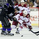 Los Angeles Kings defenseman Jake Muzzin (6) battles Phoenix Coyotes center Lauri Korpikoski (28), of Finland, for the puck during the first period of an NHL hockey game, Monday, March 18, 2013, in Los Angeles. (AP Photo/Gus Ruelas)