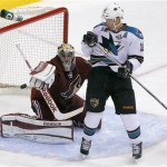 San Jose Sharks' Patrick Marleau (12) tries to avoid a shot on goal as Phoenix Coyotes' Mike Smith deflects the shot during the third period of an NHL hockey game, Wednesday, April 24, 2013, in Glendale, Ariz. The Coyotes won 2-1. (AP Photo/Matt York)