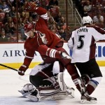 Phoenix Coyotes' Martin Hanzal (11), of the Czech Republic, flips over Colorado Avalanche's Jean-Sebastien Giguere as the Avalanche's Shane O'Brien (5) goes after the puck during the second period in an NHL hockey game, on Friday, April 26, 2013, in Glendale, Ariz. (AP Photo/Ross D. Franklin)