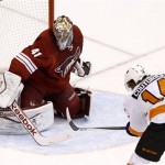 Philadelphia Flyers' Sean Couturier (14) has his shot blocked by Phoenix Coyotes' Mike Smith (41) during the first period of an NHL hockey game Saturday, Jan. 4, 2014, in Glendale, Ariz. (AP Photo/Ross D. Franklin)
