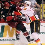 Phoenix Coyotes defenseman Rostislav Klesla, left, of the Czech Republic, is checked by Calgary Flames right winger Tim Jackman, right, in the first period of an NHL hockey game, Monday, Feb. 18, 2013, in Glendale, Ariz. (AP Photo/Paul Connors)