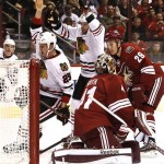 Chicago Blackhawks' Bryan Bickell (29) celebrates goal by teammate Viktor Stalberg (25), of Sweden, as Phoenix Coyotes' Mike Smith (41) and Michael Stone (29) look on during the first period in an NHL hockey game Thursday, Feb. 7, 2013, in Glendale, Ariz.(AP Photo/Ross D. Franklin)