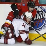  Phoenix Coyotes' Tim Kennedy, right, gets tangled up with Calgary Flames' Ladislav Smid, from the Czech Republic, during second period NHL hockey action in Calgary, Canada, Wednesday, Jan. 22, 2014. (AP Photo/The Canadian Press, Jeff McIntosh)