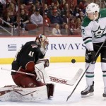  Phoenix Coyotes' Mike Smith (41) makes a save on a shot by Dallas Stars' Alex Chiasson (12) as Coyotes' Derek Morris (53) looks on during the first period of an NHL hockey game Tuesday, Feb. 4, 2014, in Glendale, Ariz. (AP Photo/Ross D. Franklin)