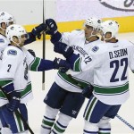 Vancouver Canucks' Ryan Kesler, far left, celebrates his goal against the Phoenix Coyotes with teammates Dan Hamhuis (2), Daniel Sedin (22), of Sweden, and Ryan Kesler during the second period of an NHL hockey game on Tuesday, Nov. 5, 2013, in Glendale, Ariz. (AP Photo/Ross D. Franklin)