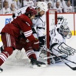 Phoenix Coyotes center Boyd Gordon, left, has his shot deflected by Los Angeles Kings goalie Jonathan Quick as Willie Mitchell (33) defends during the first period of Game 5 of the NHL hockey Stanley Cup Western Conference finals, Tuesday, May 22, 2012, in Glendale, Ariz. (AP Photo/Matt York)