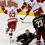 Detroit Red Wings' Johan Franzen (93), of Sweden, celebrates his goal against Phoenix Coyotes' Jason LaBarbera (1) with Niklas Kronwall (55), of Sweden, as Coyotes' Oliver Ekman-Larsson (23), of Sweden, watches in the second period during an NHL hockey game, Monday, March 25, 2013, in Glendale, Ariz. (AP Photo/Ross D. Franklin)