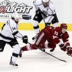 Phoenix Coyotes defenseman Oliver Ekman-Larsson (23) passes the puck as Los Angeles Kings right wing Justin Williams (14) and Anze Kopitar (11) defend during the first period of Game 5 of the NHL hockey Stanley Cup Western Conference finals, Tuesday, May 22, 2012, in Glendale, Ariz. (AP Photo/Ross D. Franklin)