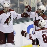 Phoenix Coyotes' Martin Hanzal (11), of the Czech Republic, is congratulated by teammates David Schlemko (6) and Mikkel Boedker (89), of Denmark, following his goal in the second period of an NHL hockey game against the Dallas Stars, Friday, Feb. 1, 2013, in Dallas. (AP Photo/Tony Gutierrez)