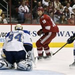 Phoenix Coyotes' David Moss (18) scores a short-handed goal against St. Louis Blues' Jake Allen (34) as Alex Pietrangelo (27) arrives late to defend in the first period of an NHL hockey game, Thursday, March 7, 2013, in Glendale, Ariz. (AP Photo/Ross D. Franklin)