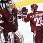 Phoenix Coyotes goalie Mike Smith, left, is congratulated by Oliver Ekman-Larsson, right, of Sweden, after Smith earned a shutout against the Colorado Avalanche in an NHL hockey game Saturday, April 6, 2013, in Glendale, Ariz. The Coyotes won 4-0. (AP Photo/Paul Connors)
