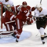 Phoenix Coyotes goalie Mike Smith (41) and teammate Oliver Ekman-Larsson (23) defend the goal in front of Anaheim Ducks right wing Corey Perry (10) during the first period of an NHL hockey game Saturday, March 2, 2013, in Glendale, Ariz. (AP Photo/Rick Scuteri)