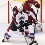  Colorado Avalanche's Cory Sarich, front, and Phoenix Coyotes' Shane Doan battle for the puck during the first period of an NHL hockey game Thursday, Nov. 21, 2013, in Glendale, Ariz. (AP Photo/Ross D. Franklin)