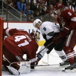 Phoenix Coyotes goalie Mike Smith (41) makes the save against San Jose Sharks center Joe Pavelski (8) in the first period during an NHL hockey game on Friday, Dec. 27, 2013, in Glendale, Ariz. (AP Photo/Rick Scuteri)