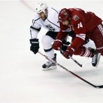 Phoenix Coyotes left wing Taylor Pyatt (14) and Los Angeles Kings left wing Dwight King (74) battle for the puck during the second period of Game 5 of the NHL hockey Stanley Cup Western Conference finals, Tuesday, May 22, 2012, in Glendale, Ariz. (AP Photo/Matt York)