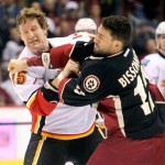 Calgary Flames right winger Tim Jackman, left, fights with Phoenix Coyotes left winger Paul Bissonnette, right, in the first period of an NHL hockey game Monday, Feb. 18, 2013, in Glendale, Ariz. (AP Photo/Paul Connors)