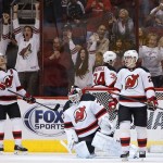  As Coyotes fans cheer for a goal by Phoenix Coyotes' Jordan Szwarz, New Jersey Devils' Patrik Elias (26), of the Czech Republic, Jon Merrill (34), Anton Volchenkov, right, of Russia, and goalie Martin Brodeur react during the first period of an NHL hockey game on Saturday, Jan. 18, 2014, in Glendale, Ariz. (AP Photo/Ross D. Franklin)