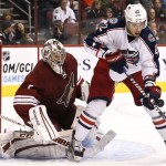Columbus Blue Jackets' Artem Anisimov (42), of Russia, tries to control the puck in front of Phoenix Coyotes' Jason LaBarbera during the second period in an NHL hockey game on Wednesday, Jan. 23, 2013, in Glendale, Ariz. (AP Photo/Ross D. Franklin)
