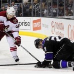 Phoenix Coyotes center Antoine Vermette (50) attempts to dig the puck from Los Angeles Kings defenseman Alec Martinez (27) during the first period of an NHL hockey game, Monday, March 18, 2013, in Los Angeles. (AP Photo/Gus Ruelas)