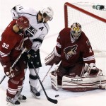 Phoenix Coyotes goalie Mike Smith, right, makes a save on a shot by Los Angeles Kings' Anze Kopitar (11), of Slovenia, as Coyotes' Michal Rozsival (32), of the Czech Republic, defends in the third period during Game 5 of the NHL hockey Stanley Cup Western Conference finals, Tuesday, May 22, 2012, in Glendale, Ariz. (AP Photo/Ross D. Franklin)