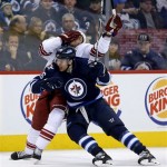 Phoenix Coyotes' David Moss (18) reacts after getting tangled up with Winnipeg Jets' Blake Wheeler (26) during second period NHL hockey action in Winnipeg, Canada, Monday, Jan. 13, 2014. (AP Photo/The Canadian Press, Trevor Hagan)