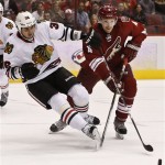 Phoenix Coyotes' Zbynek Michalek (4), of the Czech Republic, gets called for tripping on Chicago Blackhawks' Dave Bolland (36) during the first period in an NHL hockey game Thursday, Feb. 7, 2013, in Glendale, Ariz.(AP Photo/Ross D. Franklin)