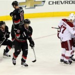 The Phoenix Coyotes, right, celebrate a goal by Shane Doan, with Carolina Hurricanes' Tuomo Ruutu (15) of Finland, Brett Bellemore (73) and Jordan Staal (11) at left during the third period of an NHL hockey game, Sunday, Oct. 13, 2013, in Raleigh, N.C. Phoenix defeated Carolina 5-3. (AP Photo/Karl B DeBlaker)