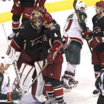 Phoenix Coyotes goalie Mike Smith, Zbynek Michalek (4), of the Czech Republic, and Oliver Ekman-Larsson (23), of Sweden, celebrate their win as Minnesota Wild Kyle Brodziak (21) and Zach Parise (11) leave the ice after the third period of an NHL hockey game, Monday, Feb. 4, 2013, in Glendale, Ariz. The Coyotes won 2-1. (AP Photo/Matt York)