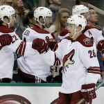 The Arizona Coyotes bench congratulates Lauri Korpikoski (28), of Finland, on his goal against the Dallas Stars in the first period of an NHL hockey game, Thursday, Nov. 20, 2014, in Dallas. (AP Photo/Tony Gutierrez)