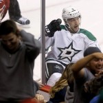 Dallas Stars' Ryan Garbutt celebrates his short-handed goal against the Arizona Coyotes as fans react in the stands during the third period of an NHL hockey game Tuesday, Nov. 11, 2014, in Glendale, Ariz. The Stars defeated the Coyotes 4-3. (AP Photo/Ross D. Franklin)