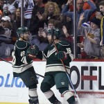 Minnesota Wild defenseman Jared Spurgeon (46) and left wing Jason Zucker celebrate a goal by Zucker against the Arizona Coyotes during the second period of an NHL hockey game Saturday, Jan. 17, 2015, in St. Paul, Minn. The Wild won 3-1. (AP Photo/Hannah Foslien)
