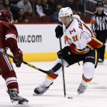Calgary Flames' Mikael Backlund (11), of Sweden, tries to skate around Arizona Coyotes' Sam Gagner (9) during the second period of an NHL hockey game Thursday, Jan. 15, 2015, in Glendale, Ariz. The Flames won 4-1. (AP Photo/Ross D. Franklin)