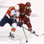 Florida Panthers' Sean Bergenheim (20), of Finland, battles Arizona Coyotes' Lauri Korpikoski, right, also of Finland, for the puck during the first period of an NHL hockey game Saturday, Oct. 25, 2014, in Glendale, Ariz. (AP Photo/Ross D. Franklin)