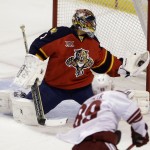  Florida Panthers goalie Roberto Luongo makes a save against Phoenix Coyotes left wing Mikkel Boedker (89), of Denmark, during the first period of an NHL hockey game, Tuesday, March 11, 2014, in Sunrise, Fla. (AP Photo/Wilfredo Lee)
