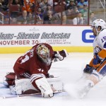 Arizona Coyotes' Mike Smith (41) makes a save on a shot by New York Islanders' Cal Clutterbuck (15) during the third period of an NHL hockey game Saturday, Nov. 8, 2014, in Glendale, Ariz. The Islanders defeated the Coyotes 1-0. (AP Photo/Ross D. Franklin)