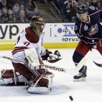 Arizona Coyotes' Mike Smith, left, makes a save against Columbus Blue Jackets' Cam Atkinson during the second period of an NHL hockey game Tuesday, Feb. 3, 2015, in Columbus, Ohio. (AP Photo/Jay LaPrete)
