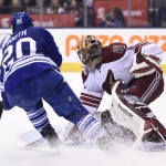 Arizona Coyotes goalie Mike Smith stops Toronto Maple Leafs' David Booth during the second period of an NHL hockey game Thursday, Jan. 29, 2015, in Toronto. (AP Photo/The Canadian Press, Frank Gunn)
