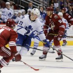 Toronto Maple Leafs right wing Carter Ashton (37) carries the pck in front of Arizona Coyotes defenseman Zbynek Michalek (4) in the first period during an NHL hockey game, Tuesday, Nov. 4, 2014, in Glendale, Ariz. (AP Photo/Rick Scuteri)