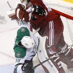 Dallas Stars' Vernon Fiddler (38) crashes into Arizona Coyotes' Mike Smith, right, during the second period of an NHL hockey game Tuesday, Nov. 11, 2014, in Glendale, Ariz. (AP Photo/Ross D. Franklin)