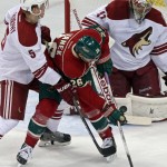 Minnesota Wild's Thomas Vanek, center, of Austria, tries to control the puck as Arizona Coyotes' Connor Murphy, left, and goalie Mike Smith defend during the first period of an NHL hockey game, Thursday, Oct. 23, 2014, in St. Paul, Minn. (AP Photo/Jim Mone)
