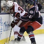 Columbus Blue Jackets' Alexander Wennberg, left, of Sweden, checks Arizona Coyotes' Lucas Lessio during the first period of an NHL hockey game Tuesday, Feb. 3, 2015, in Columbus, Ohio. (AP Photo/Jay LaPrete)
